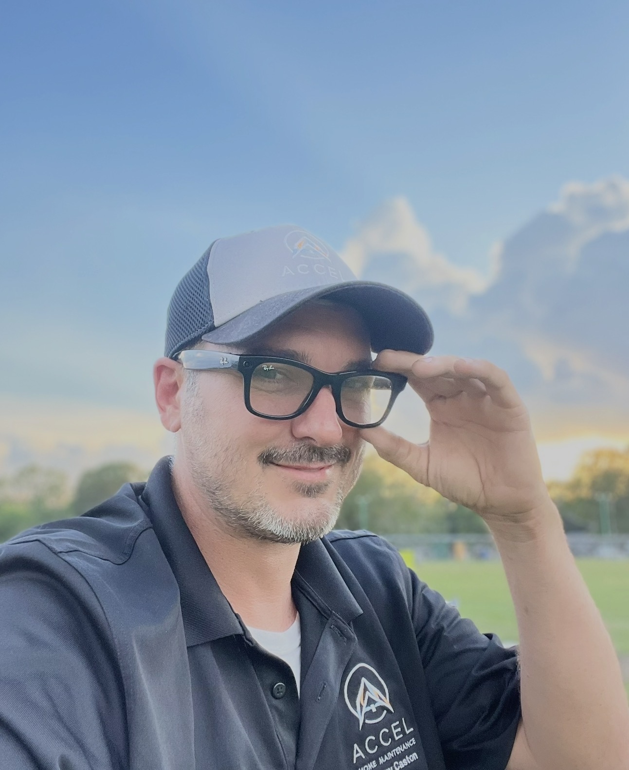 Johnny Caston wearing his Accel Home Maintenance shirt and cap