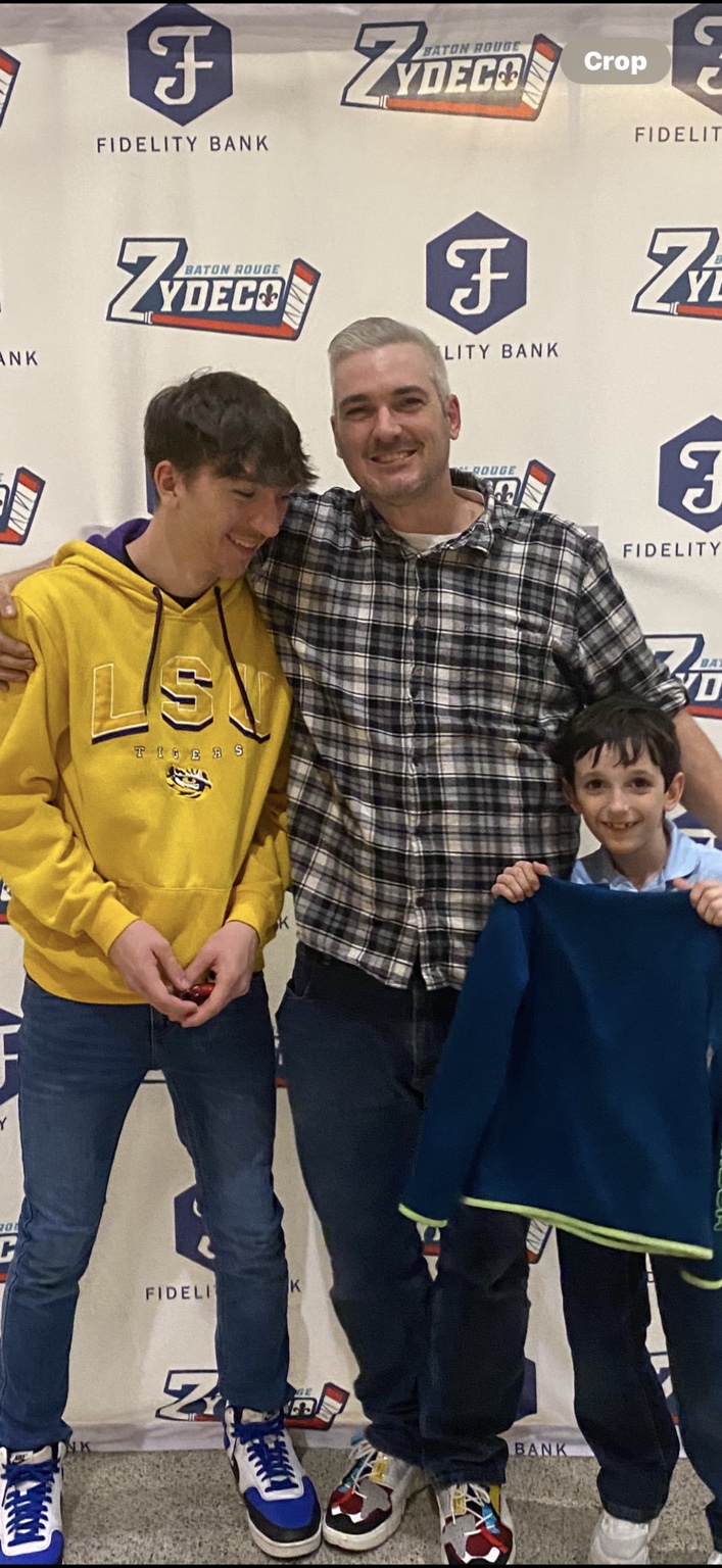 Johnny and his two sons together at a Baton Rouge hockey event