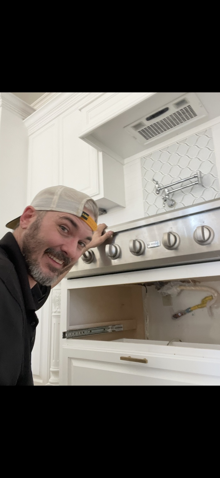 Johnny working beside a kitchen range during installation